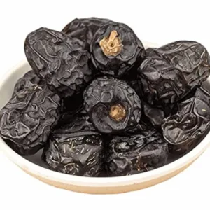 Close-up view of fresh black Ajwa dates texture